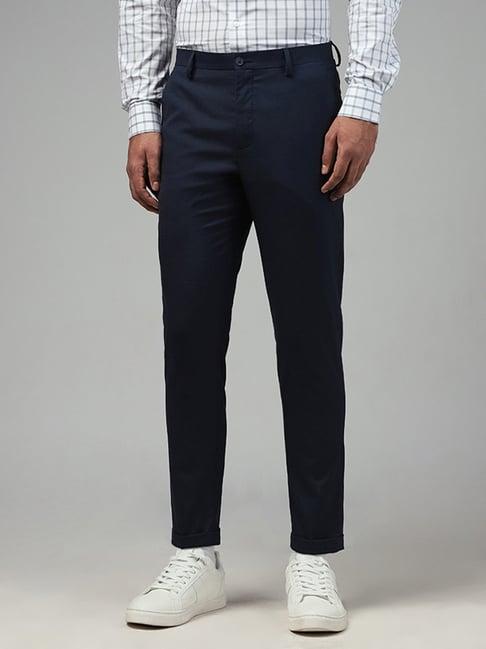 wes formals by westside solid navy blue carrot fit trousers