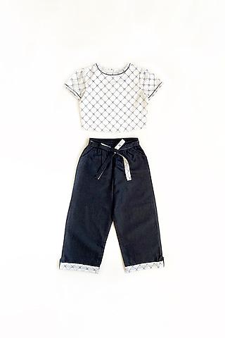 white printed top with blue pants for girls