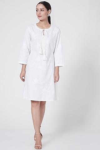 white embroidered dress with tassels