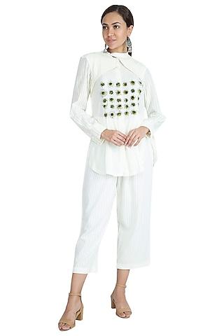 white embroidered top with pants