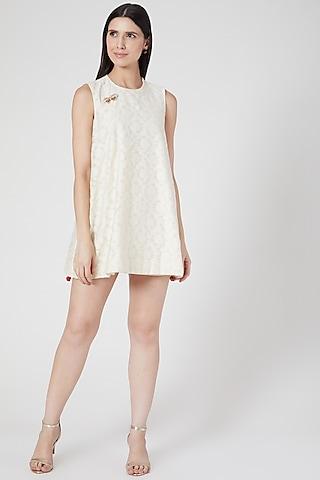 white mini dress with butterfly brooch