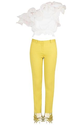 white ruffled crop top with iris yellow tasseled pants