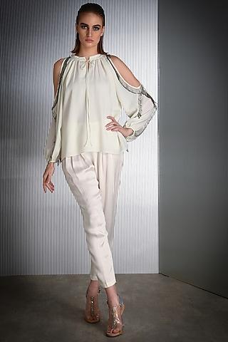 white top with metallic tassels
