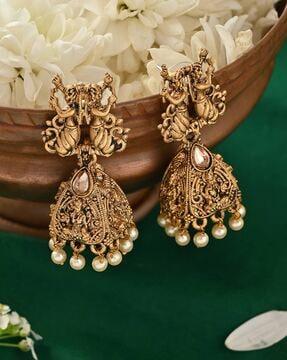 women stone-studded jhumka earrings
