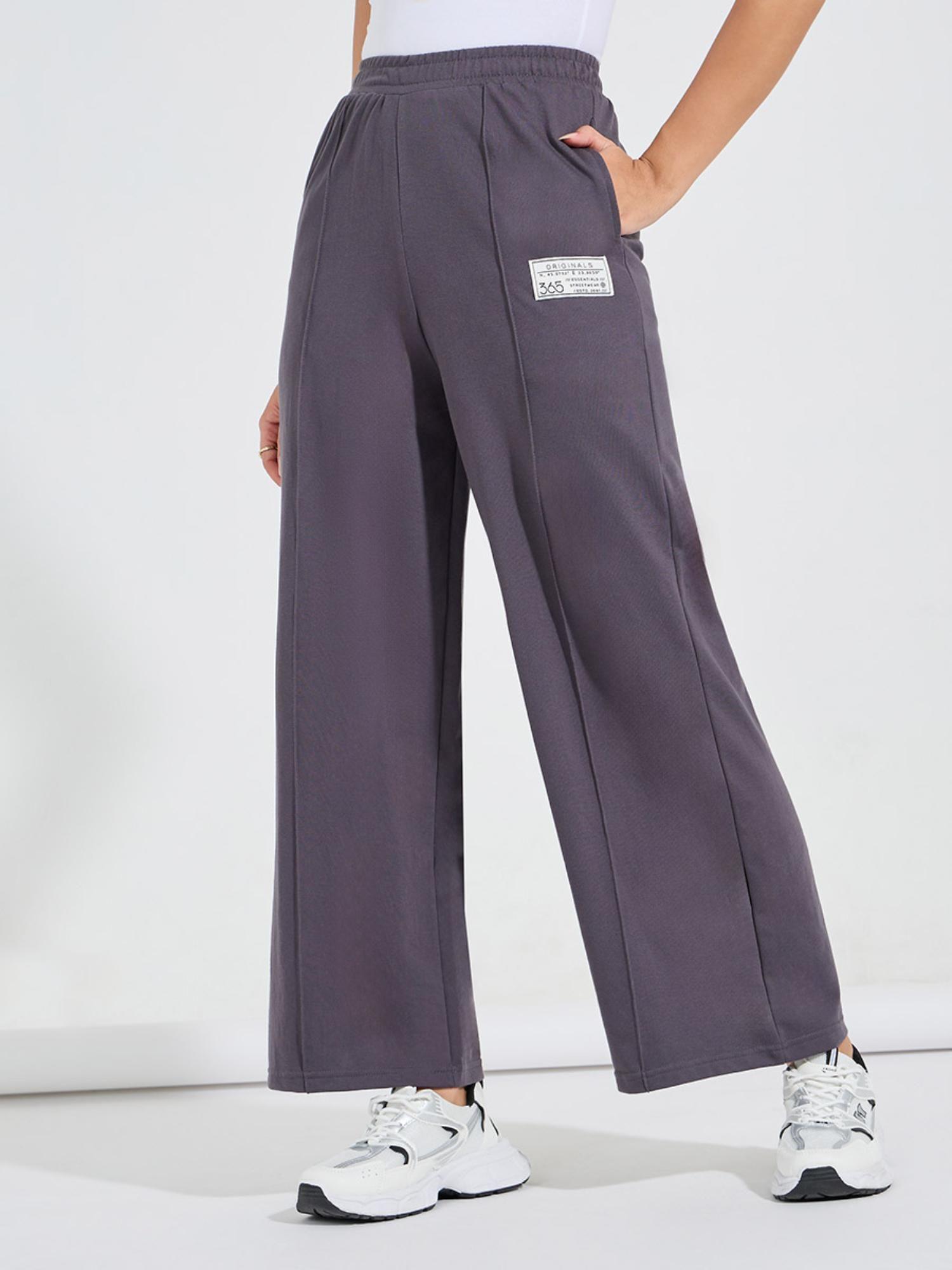 women charcoal solid high waisted flared leg pintuck pants with badge detail