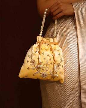 women embellished potli bag with tassels