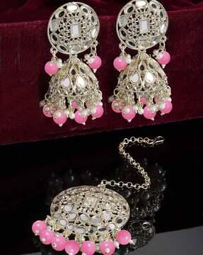 women gold-plated stone-studded jhumka earrings with mangtika
