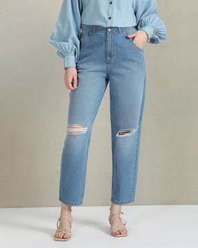 women lightly washed distressed carrot fit jeans