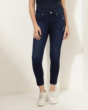 women lightly washed distressed skinny jeans