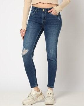 women lightly washed slim fit distressed jeans