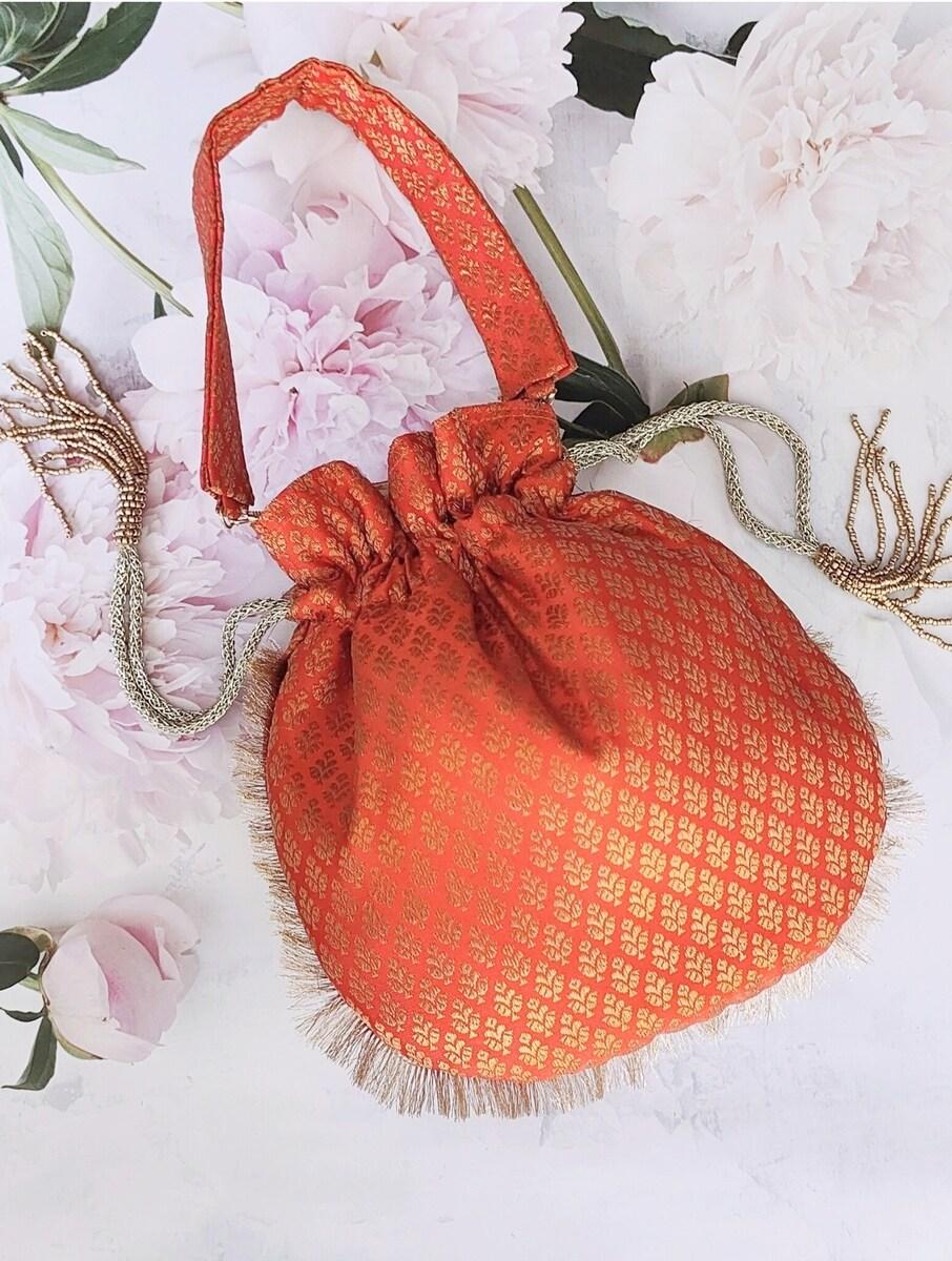 women orange silk potli