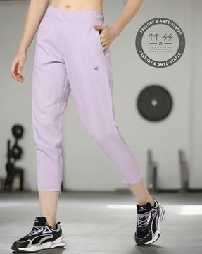 women running cropped track pants