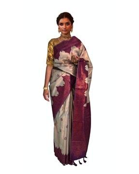 women saree with woven motifs & tassels