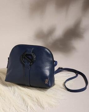 women sling bag with metal logo