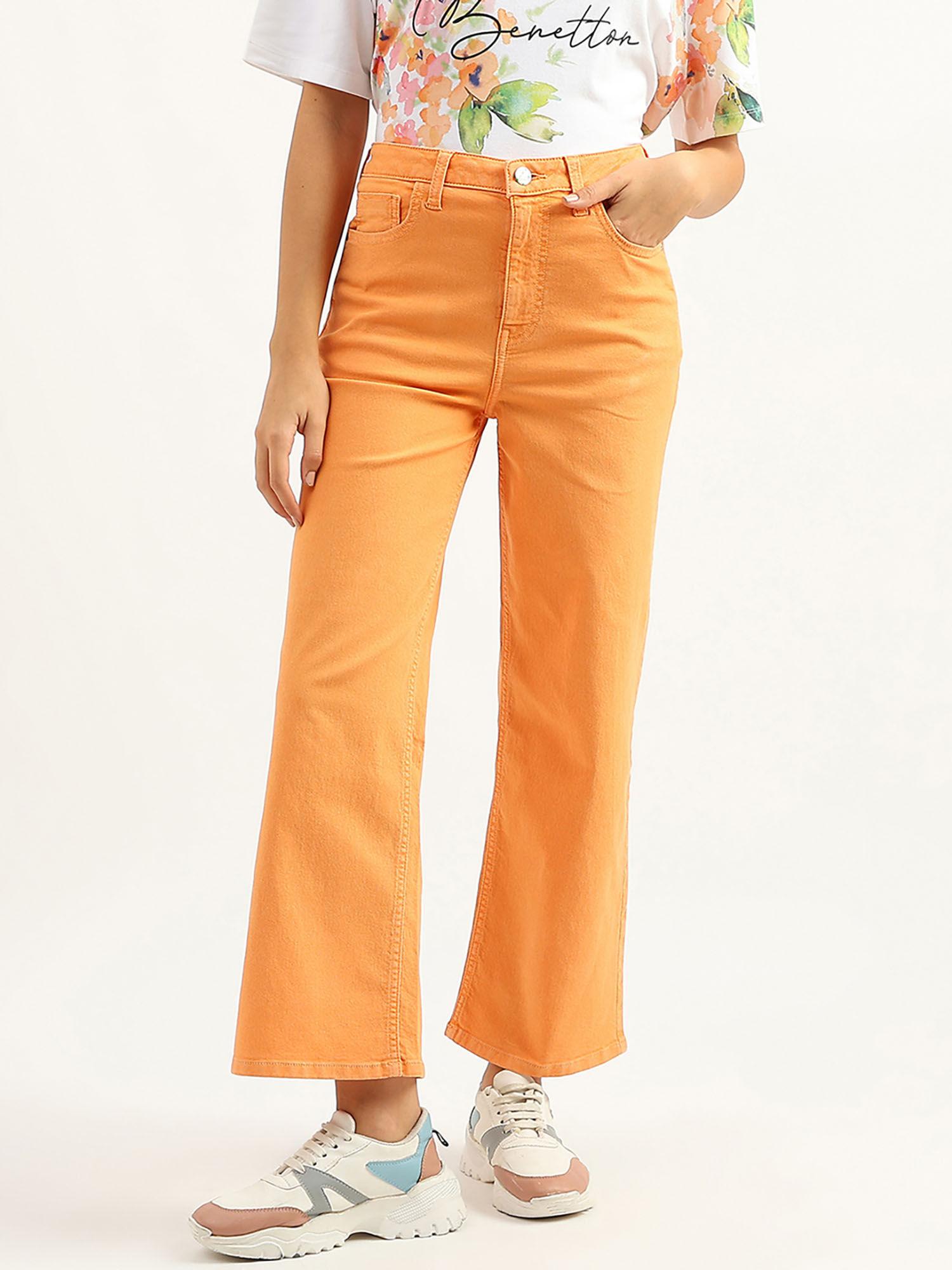 women solid flared fit orange jeans