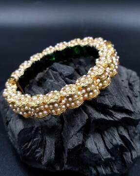 women stone-studded bangle