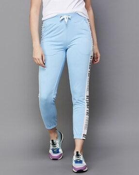 women striped straight fitted track pants with ankle length