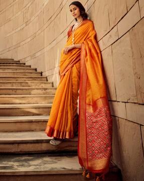 women woven saree with contrast border & tassels