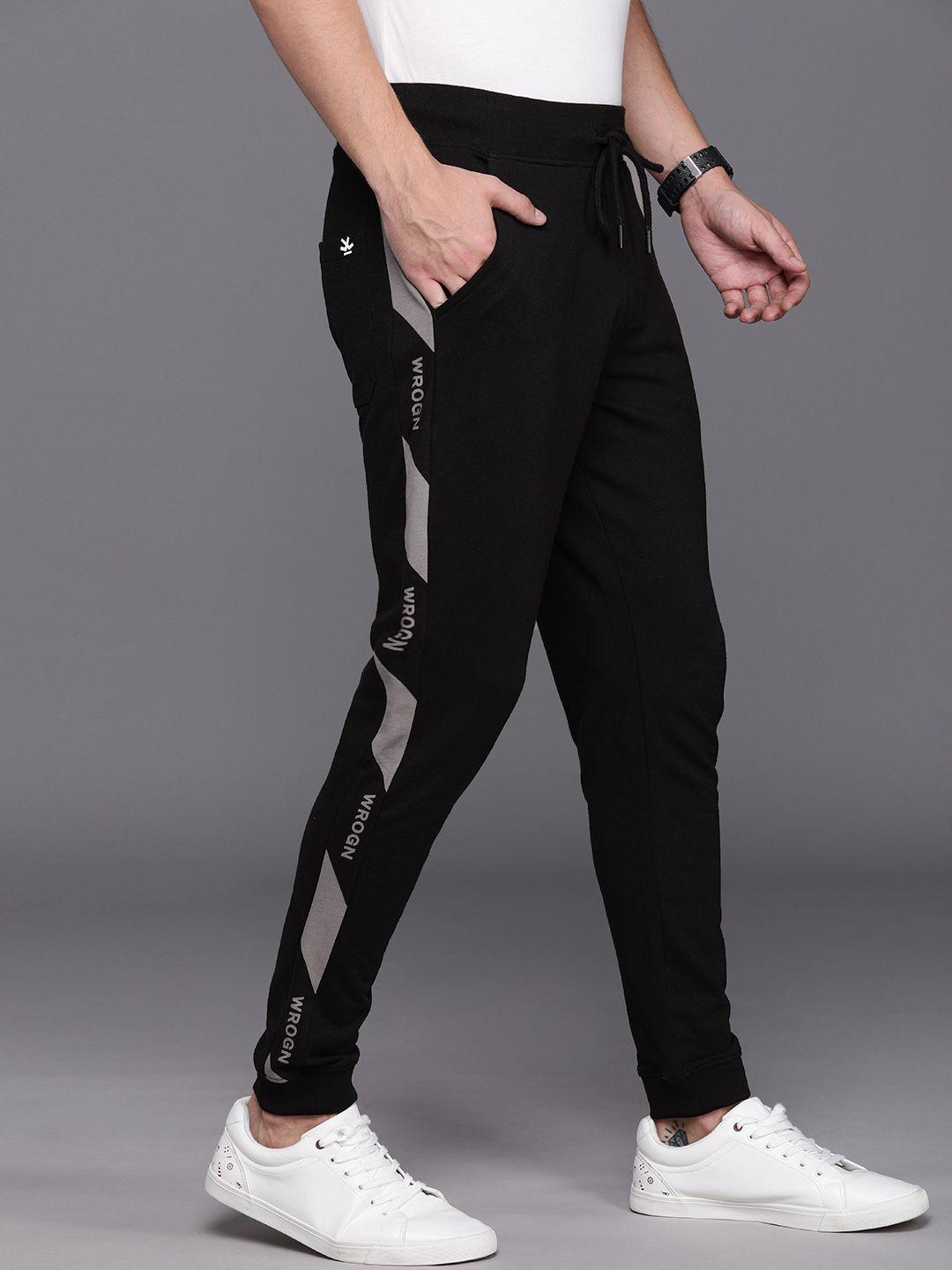 wrogn men black solid slim fit joggers with printed side stripe