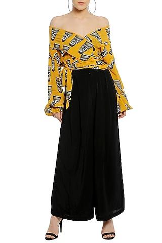 yellow off shoulder printed wrap top with black palazzo pants