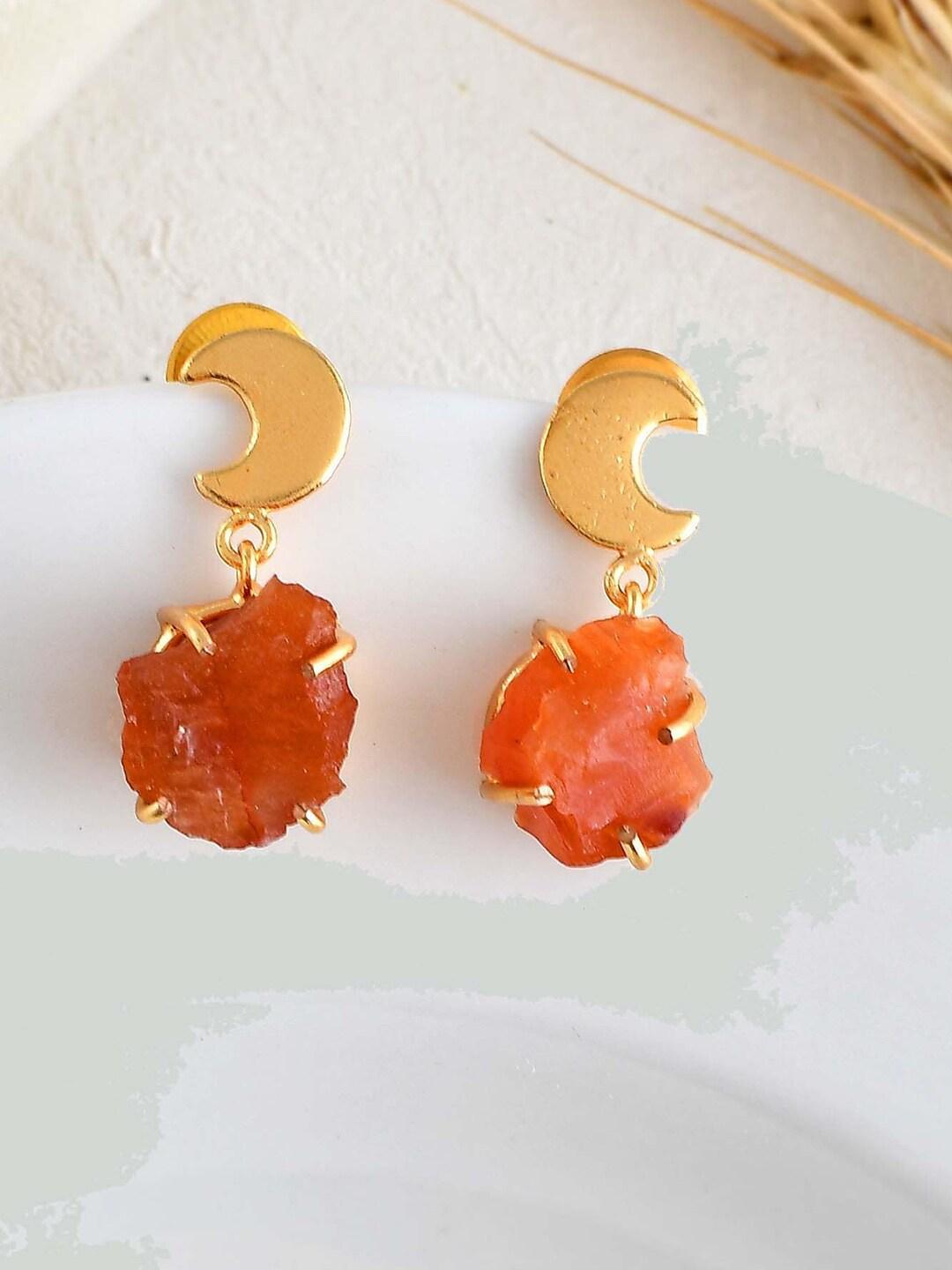 zurii stones studded crescent shaped drop earrings